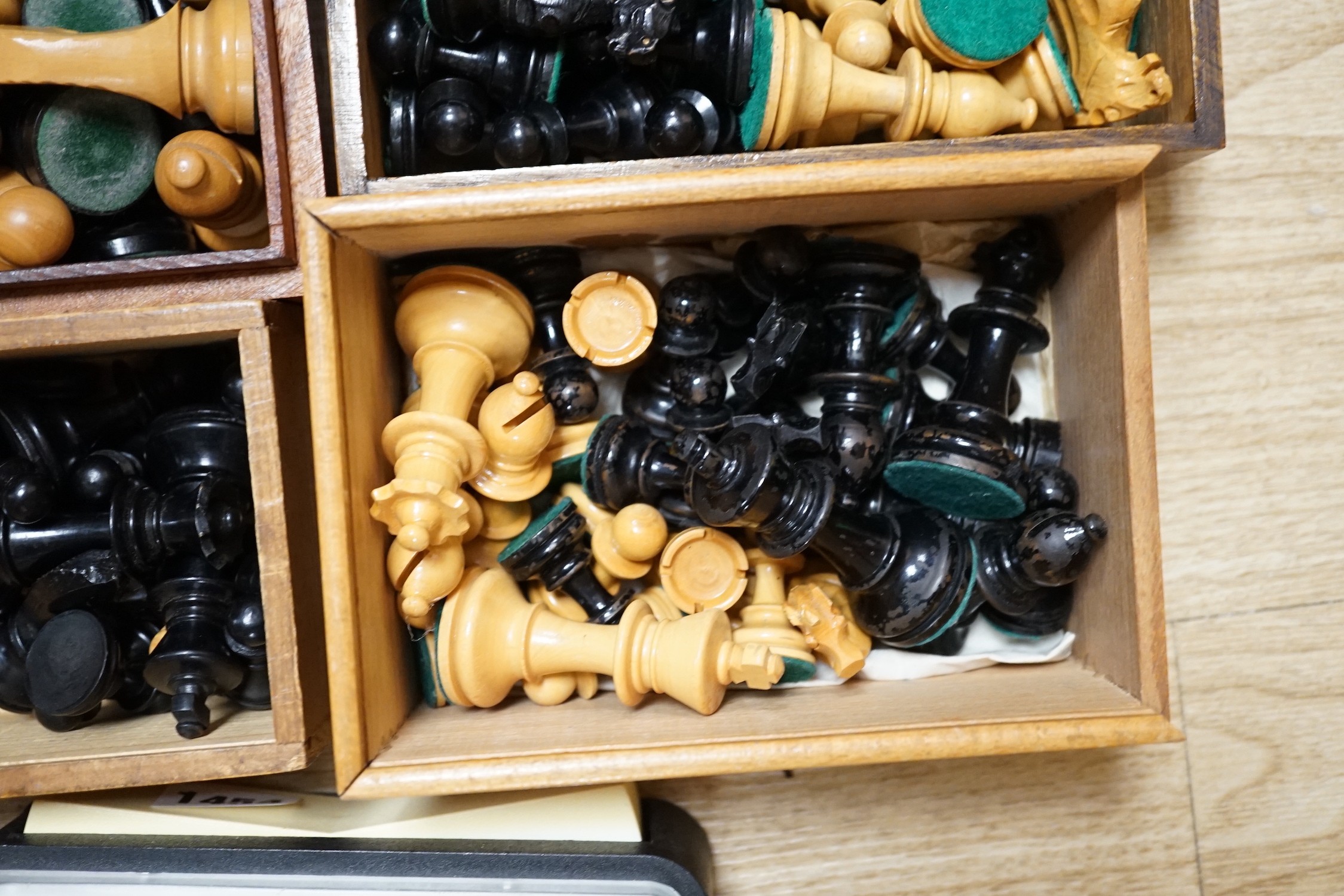 A collection of four wooden chess sets and a clock